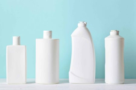 Plastic white bottles on a light blue background.